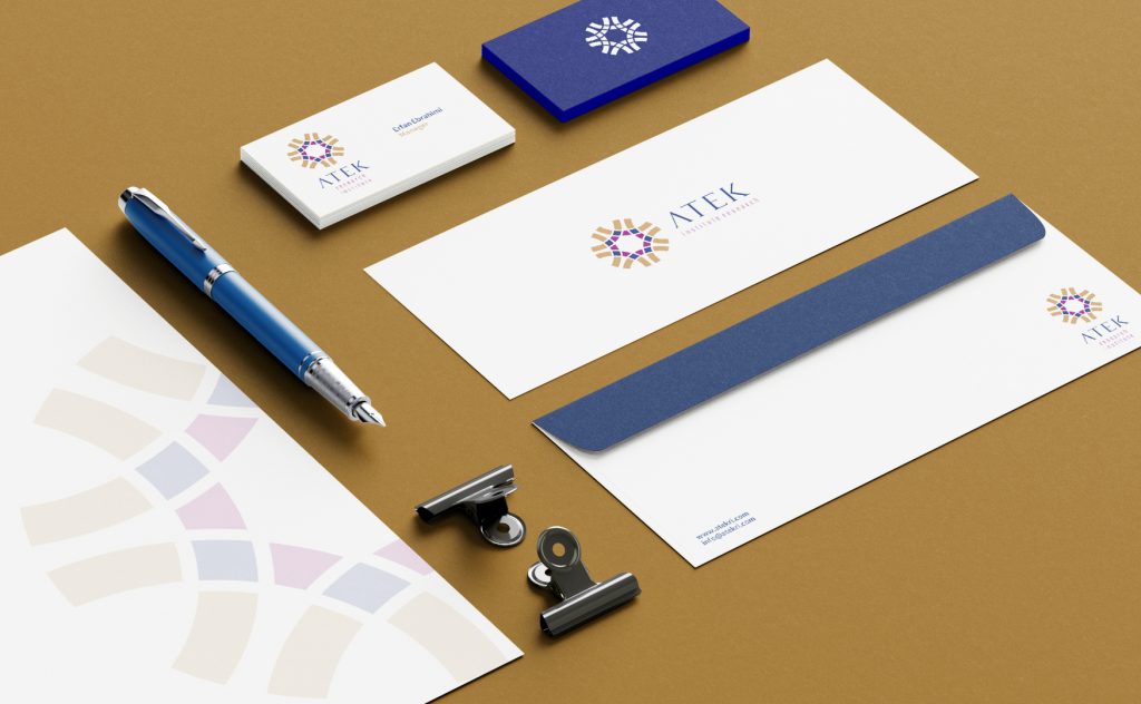 ATEK Research Institute stationery set including business card, envelope, and letterhead with official logo