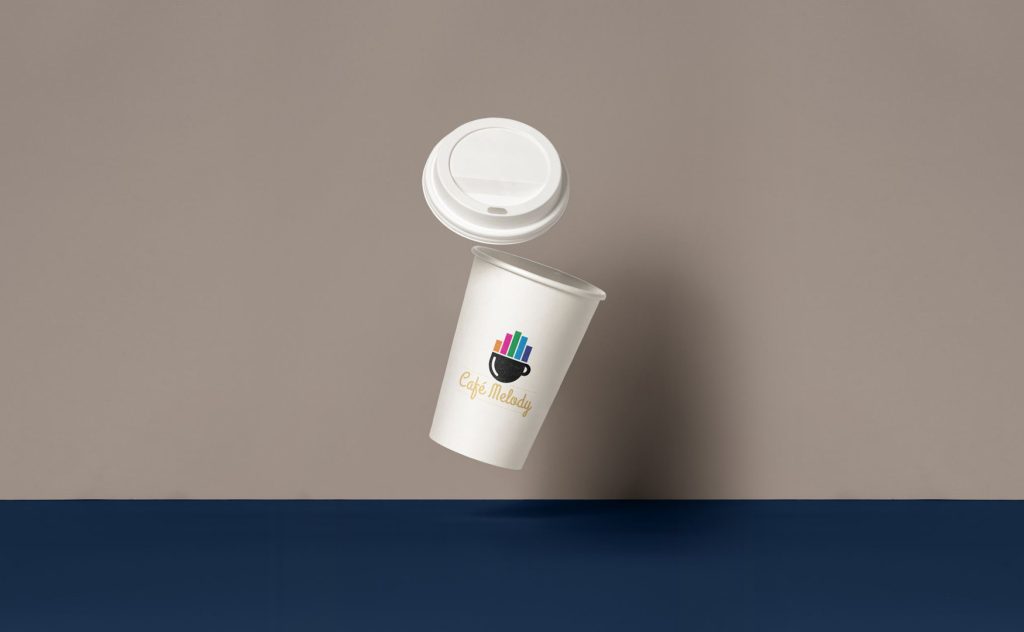 White paper cup with Café Melody logo featuring a coffee cup and colorful music bars