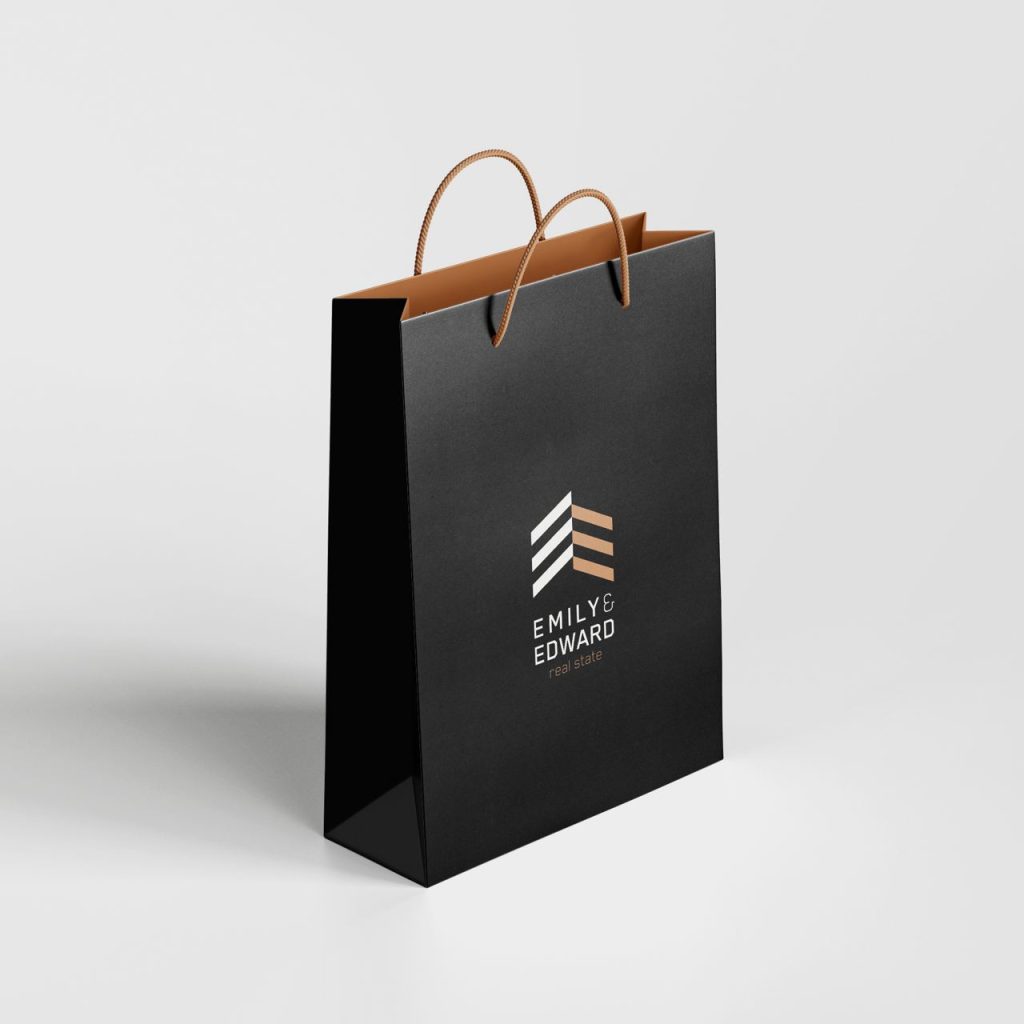 Emily & Edward real estate logo on a black shopping bag with golden-beige interior and handles