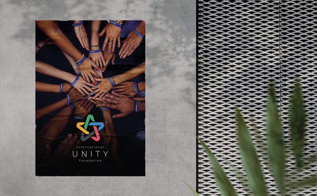 Unity Foundation logo design on poster with joined hands symbolizing unity